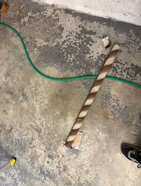 Broken garage door spring removed St. Louis